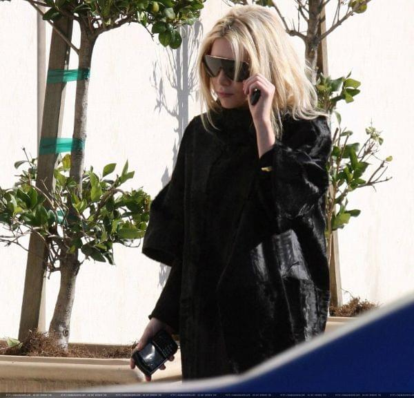 Ashley out and about in a black fur coat